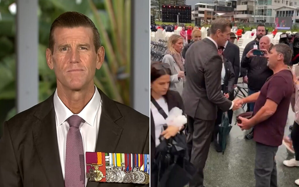 Close-up of a man in a suit with many medals on his chest, looking straight ahead.