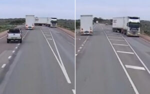 Two-lane rural highway with a large white semi-trailer in the left lane ahead of a white pickup, and a white SUV approaching from behind on the near lane.