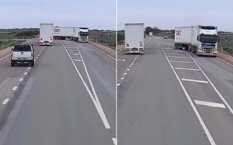 Two-lane rural highway with a large white semi-trailer in the left lane ahead of a white pickup, and a white SUV approaching from behind on the near lane.