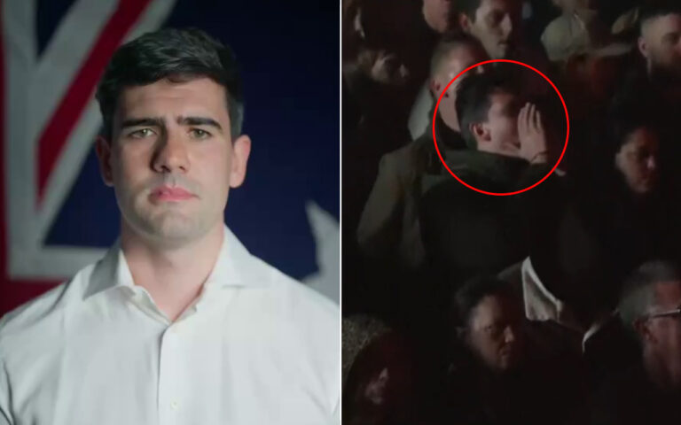 Portrait of a man in a white shirt with a flag background, looking straight at the camera (informative headshot).