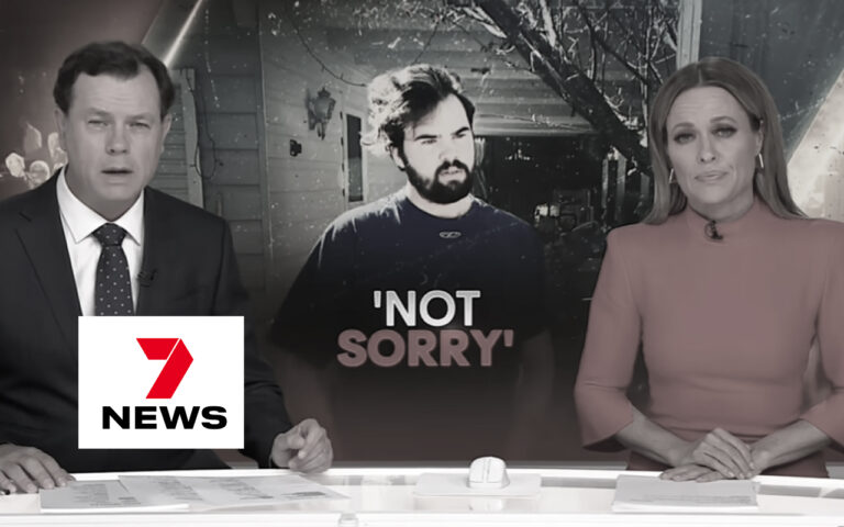 TV news broadcast with two anchors at a desk; the center background shows a man and the words NOT SORRY overlayed on screen, logo partially obscured on left.