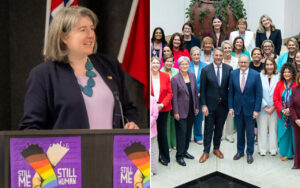 Speaker at podium delivering remarks about 'Still Me, Still Human' with rainbow hands poster visible on lectern; audience group photo of diverse professionals in business attire behind.