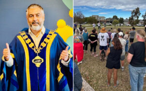 Male official in blue ceremonial gown with gold trim and a large gold chain, giving thumbs up.