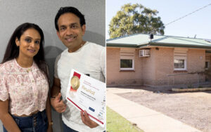 Man and woman pose with a finalist certificate for an awards event, smiling at the camera in a hallway.