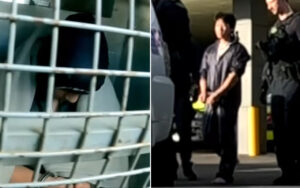 Person behind metal bars wearing a dark helmet, visible in a jail cell window. (informative image)