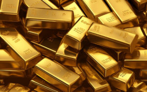 Pile of shiny gold bars stacked together, gleaming in warm light.