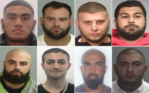 Collage of eight mugshots showing men with neutral expressions, arranged in a grid, each head-and-shoulders photo against plain backgrounds.