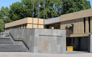 Exterior view of the Supreme Court of Tasmania with a stepped staircase and a grey stone wall leading to the entrance.