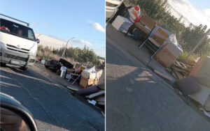 White van on a sunlit street with debris and cardboard boxes scattered along the curb near a chain-link fence on the side of the road.