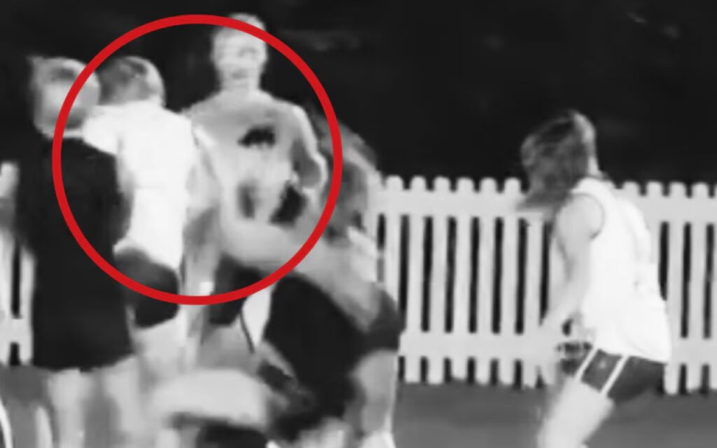 Two people appear to be pushing or shoving each other near a white picket fence, with a red circle highlighting the interaction.
