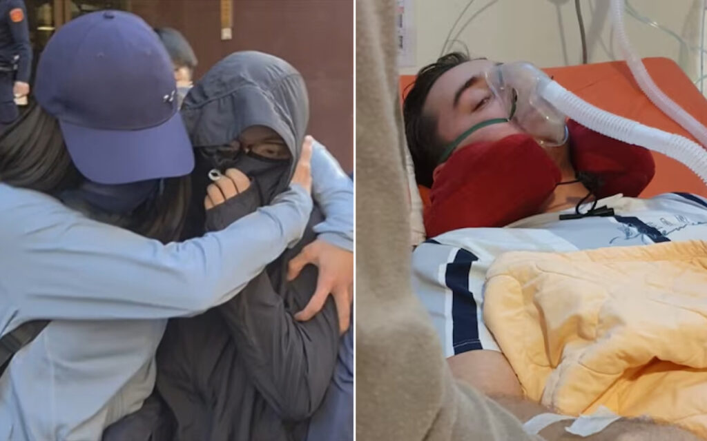 Two people hug outdoors, one in a blue cap and hijab, offering comfort to the other in a dark jacket. On the right, a man lies in a hospital bed wearing an oxygen mask with tubing nearby.