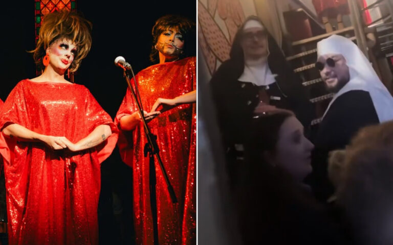 Two drag queens in red sequined gowns performing on a stage with a microphone stand nearby.