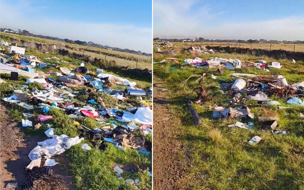 Litter spread across a grassy field along a dirt path: plastic bags, clothes, and discarded items left scattered.