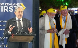 Politician speaking at a podium in front of a New Zealand First banner at a formal event.