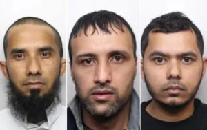 Three mugshots: left—bearded man with shaved head; center—man with short dark hair and stubble; right—man with short hair and light beard, all facing forward.