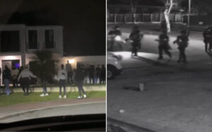 Night scene showing a group of people gathered outside a building; a split view with armed officers on the right side near the street at night.