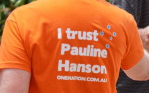 Orange shirt with bold white text: 'I trust Pauline Hanson' and 'onenation.com.au'.