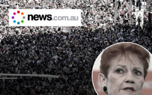 Large crowd of protesters fills a street with a News.com.au logo overlay; circular inset shows a woman speaking.