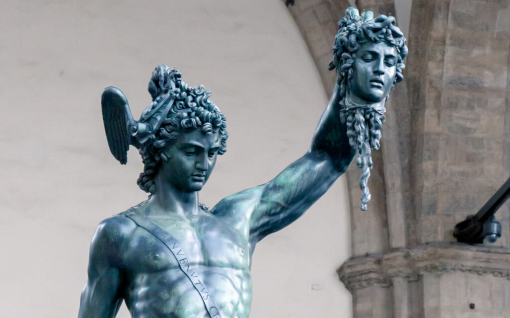 Bronze statue of Perseus holding the severed head of Medusa aloft, wearing a winged helmet.
