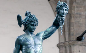 Bronze statue of Perseus holding the severed head of Medusa aloft, wearing a winged helmet.